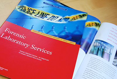 A red cover and interior spread of an annual report for the Forsensic Laboratory Services featuring a photo of a police line do not cross tape