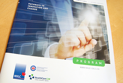 National Health Leadership Conference program brochure cover featuring a photo of a hand touching a virtual screen